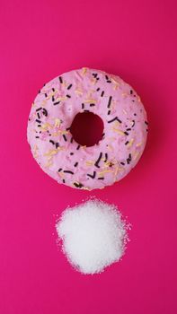 Doughnut with sugar on pink background. Sweet donuts. Diet and unhealthy diet concept.