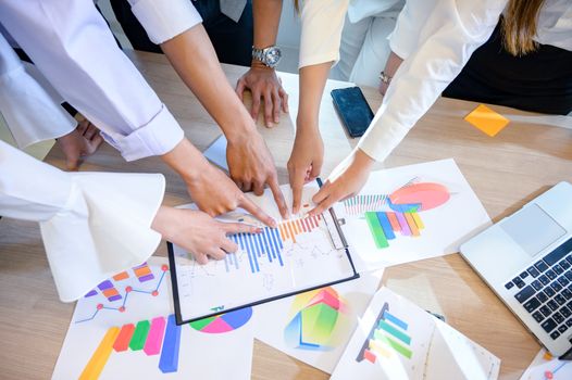 Business people are meeting and graphing business growth on a desk