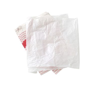 Creased sheet of white wax paper (butcher paper) on tea towel isolated on white