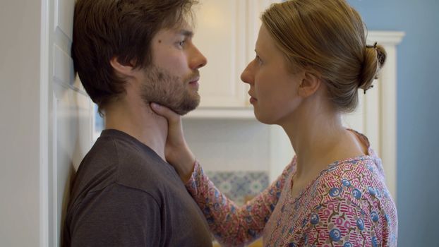 Angry woman strangling her husband. Close up portrait of an angry wife, something dissatisfied and aggressively expressing it. Home conflict, violence and abuse