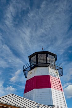 Red and White Lighthouse under blue skies