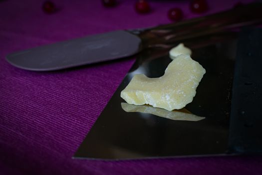 Close-up of a professional artisan pastry shop. A piece of white chocolate is prepared for home cooking useful and delicious sweets