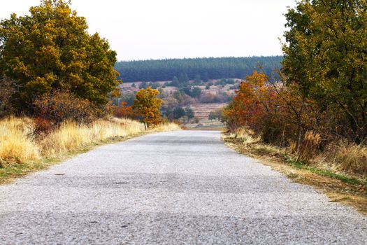 Long straight road with dramatic clouds