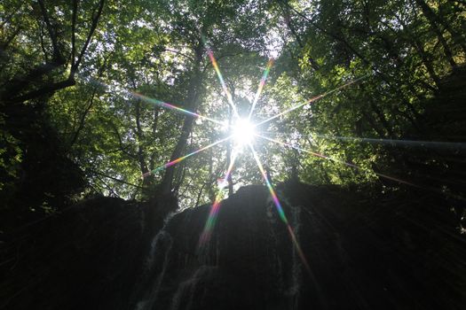 waterfall in forest sun ray