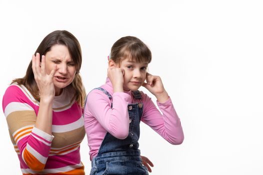 Girl sneezes, child plugged ears, isolated on white background