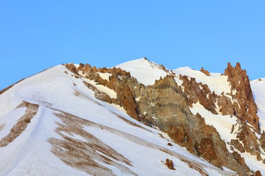 Strict and majestic peaks of Mount Erciyes on a clear sunny day against the blue clear sky in central Anatolia, Turkey.