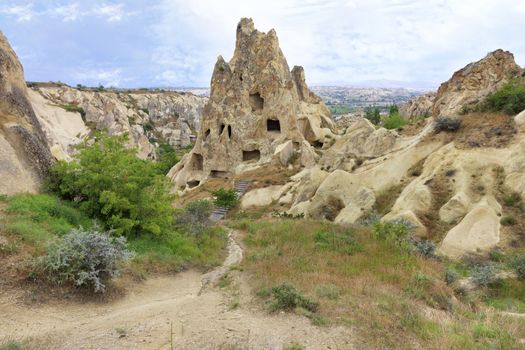 Antique landscape and view of ancient cone-shaped residential caves in the mountain landscape in the valleys of Cappadocia central Turkey