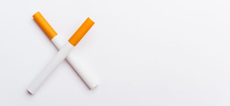 31 May of World No Tobacco Day, no smoking sign two cigarettes crossed slashes close up full pile cigarette or tobacco on white background with copy space, and Warning lung health concept