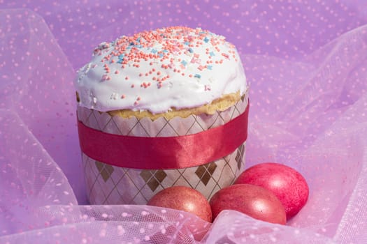 Easter cake decorated with pink decor and rose-colored eggs