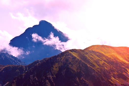 Fog in mountains. Fantasy and colorfull nature landscape. Nature conceptual image.