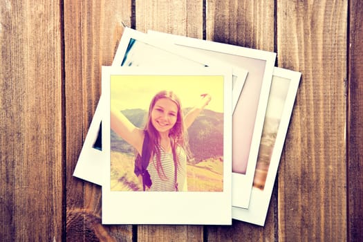 Happy teenage girl on instant photo frame on wooden background. Vintage retro.