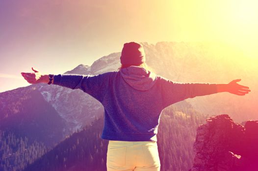 Teenage girl feel freedom in mountains scenery. Vintage instagram picture.