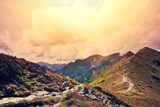Fantasy and colorfull nature mountains landscape. Nature conceptual image. Instagram vintage sunburst picture.