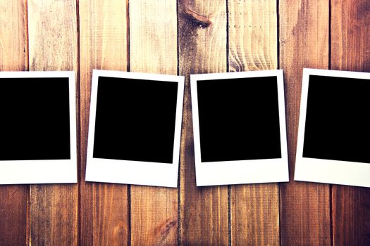 Instant blank photo frames on wooden background. Free copyspace. Vintage retro.