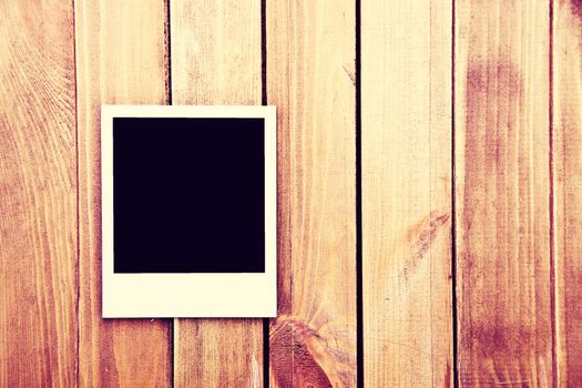 Instant blank polaroid photos frame on wooden background. Free copyspace. Vintage retro.