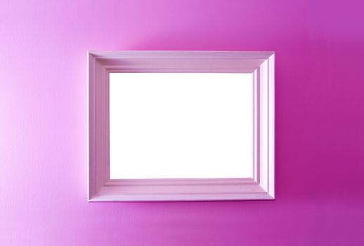 White empty frame on the pink wall. Free copy space.