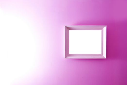 White empty frame on the pink wall. Free copy space.