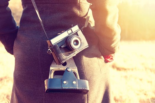 Young hipster girl with retro vintage camera. Instagram vintage picture.