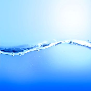 Water wave and air bubbles. Blue background.
