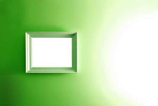 White empty frame on the green wall. Free copy space.