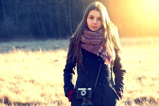 Young hipster girl with retro vintage camera. Instagram vintage picture.