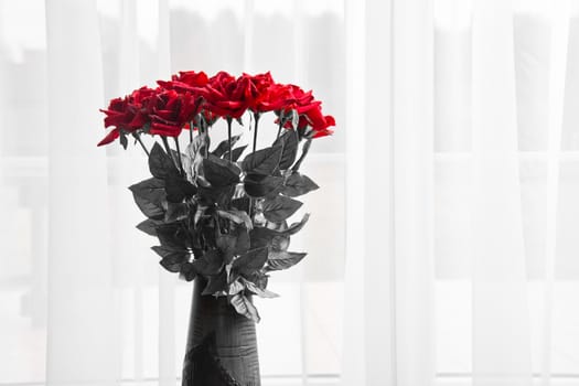 Bouquet of fresh red roses in a vase. Love and romance.