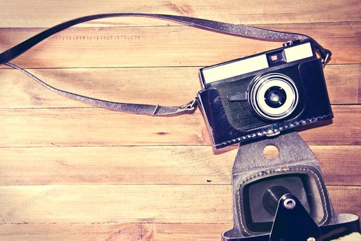 Retro vintage camera on wooden background. Instagram retro vintage picture.