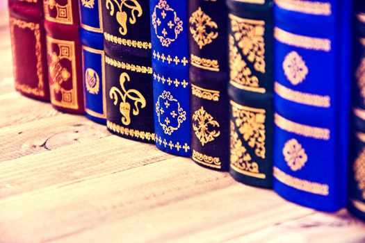 Old vintage retro books on the wooden table.