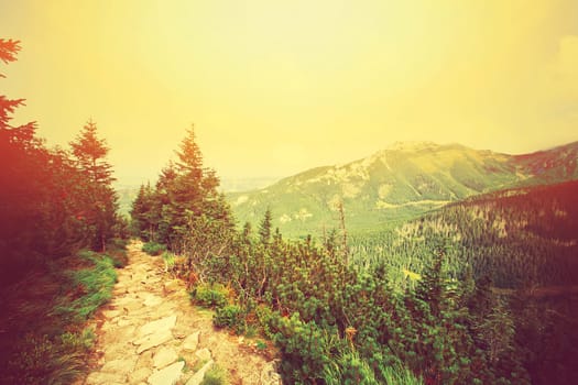 Colorfull mountains landscape. Retro instagram sunburst vintage picture.