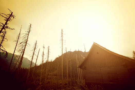 Mountains abstract nature landscape. Wooden house in mountains.