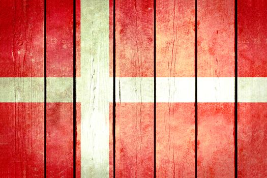 Denmark wooden grunge flag. Denmark flag painted on the old wooden planks. Vintage retro picture from my collection of flags.