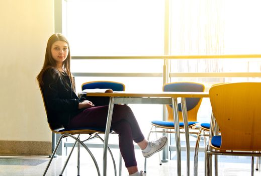 Pretty young student girl studying in the university. Education conceptual image.