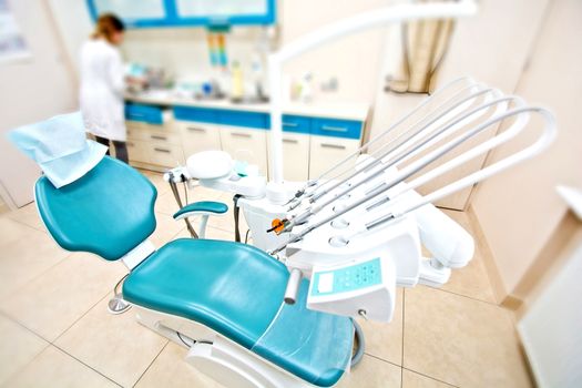 Professional Dentist tools and chair in the dental office. Dental Hygiene and Health conceptual image.