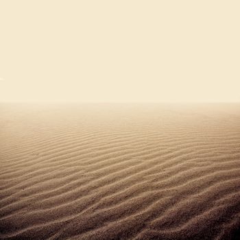 Sand on the dry desert. Minimalist abstract picture in dark pastel colors.