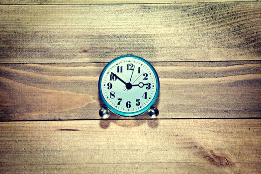Old clock on the wooden background. Retro vintage picture. Time concept.