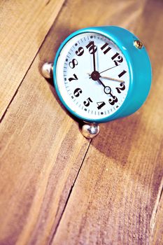 Old clock on the wooden background. Retro vintage picture. Time concept.