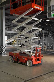 distribution warehouse hall with hydraulic scissors lift platform
