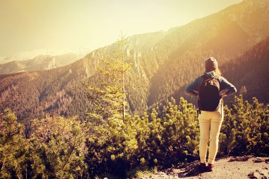Tourism in mountains. Teenage girl on the mountain path. Vintage instagram picture.