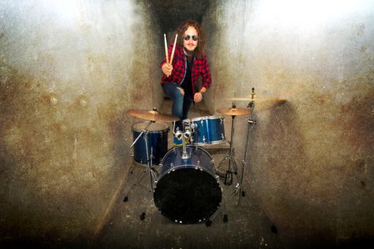 Drums conceptual image. Rock drummer holding drumsticks and playing on drums. Retro vintage grunge picture.