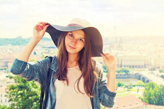 Beautiful charming tourist girl with hat on her head. Tourism concept. Retro vintage picture.