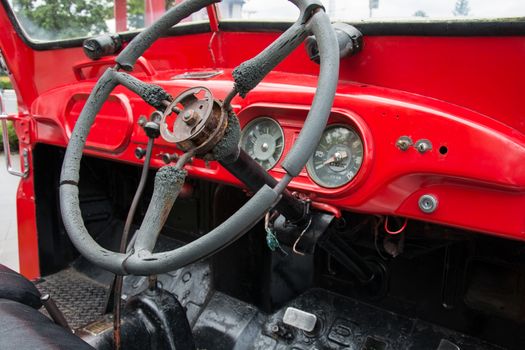 Steering wheel and dashboard in interior of old retro automobile. Processed by vintage or retro effect filter