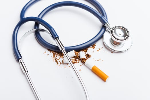 31 May of World No Tobacco Day, no smoking, close up of broken pile cigarette or tobacco and doctor stethoscope on white background with copy space, and Warning lung health concept