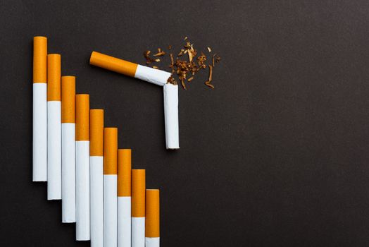 31 May of World No Tobacco Day, Close up step staircase pile cigarette or tobacco on black background with copy space, Smoking reduction campaign and Warning lung health concept