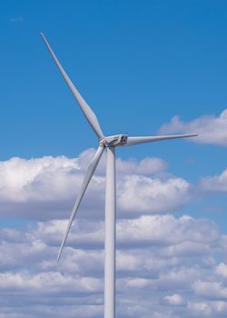 Parutino, Ukraine 08.17.2019. Wind generators in a sunflower field against a cloudy sky near the Ancient greek colony Olbia in Ukraine on a sunny summer day