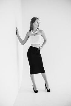 girl in a white blouse and black skirt on a white background