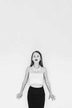 girl in a white blouse and black skirt on a white background