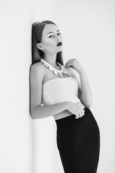 girl in a white blouse and black skirt on a white background