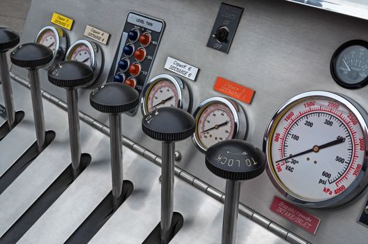 Instrument panel of a fire truck made of stainless steel and plastic.