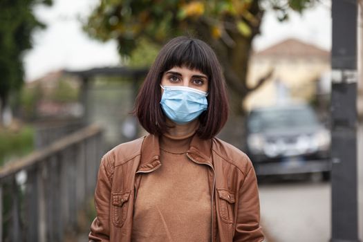 Close up portrait of a Girl with medical mask outdoor during covid quarantine in Italy