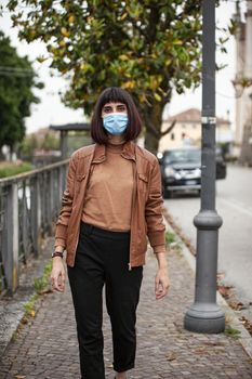 Portrait of a Girl with medical mask outdoor during covid quarantine in Italy